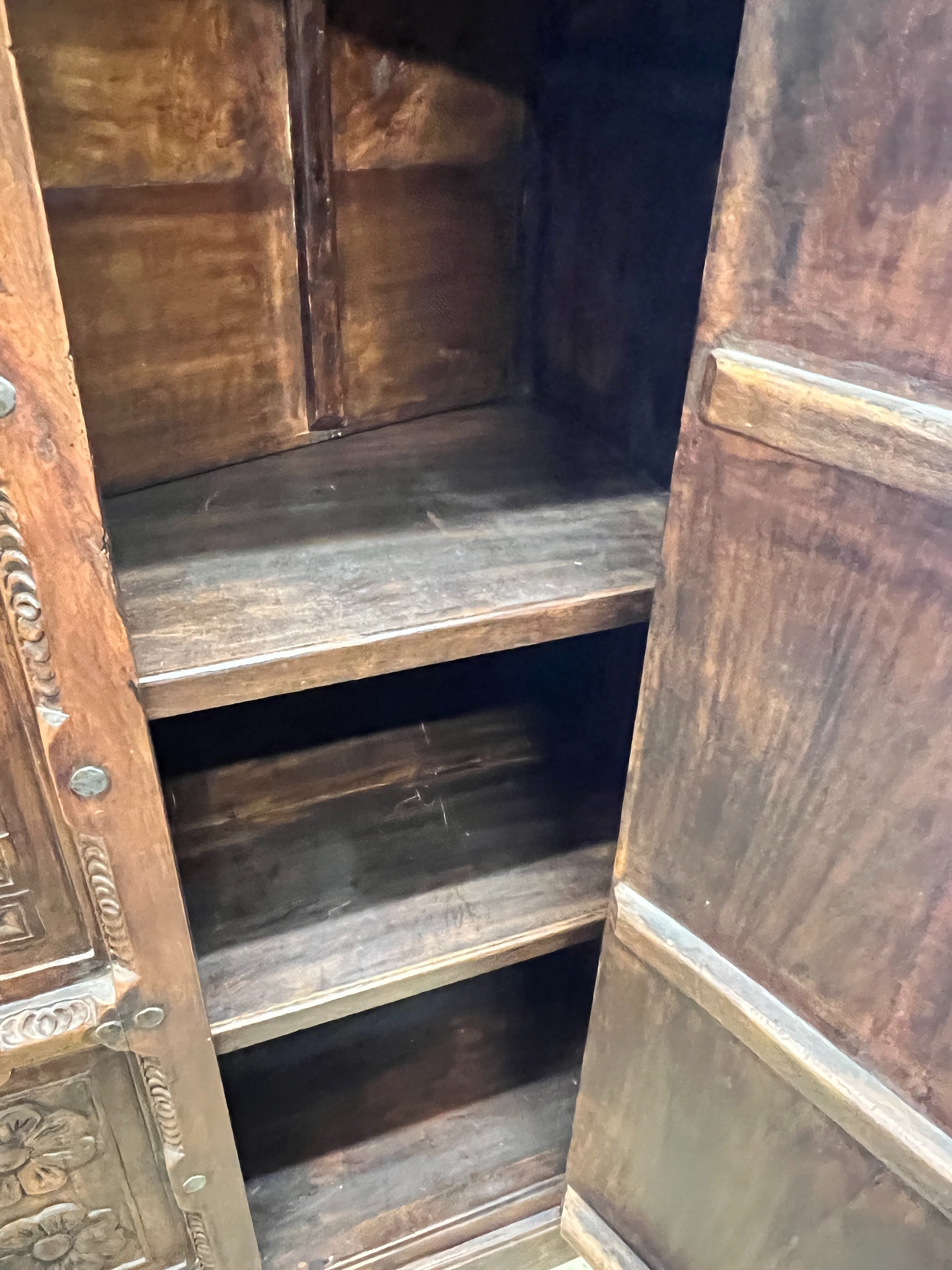 An Eastern carved hardwood two door cabinet, width 119cm, depth 67cm, height 192cm